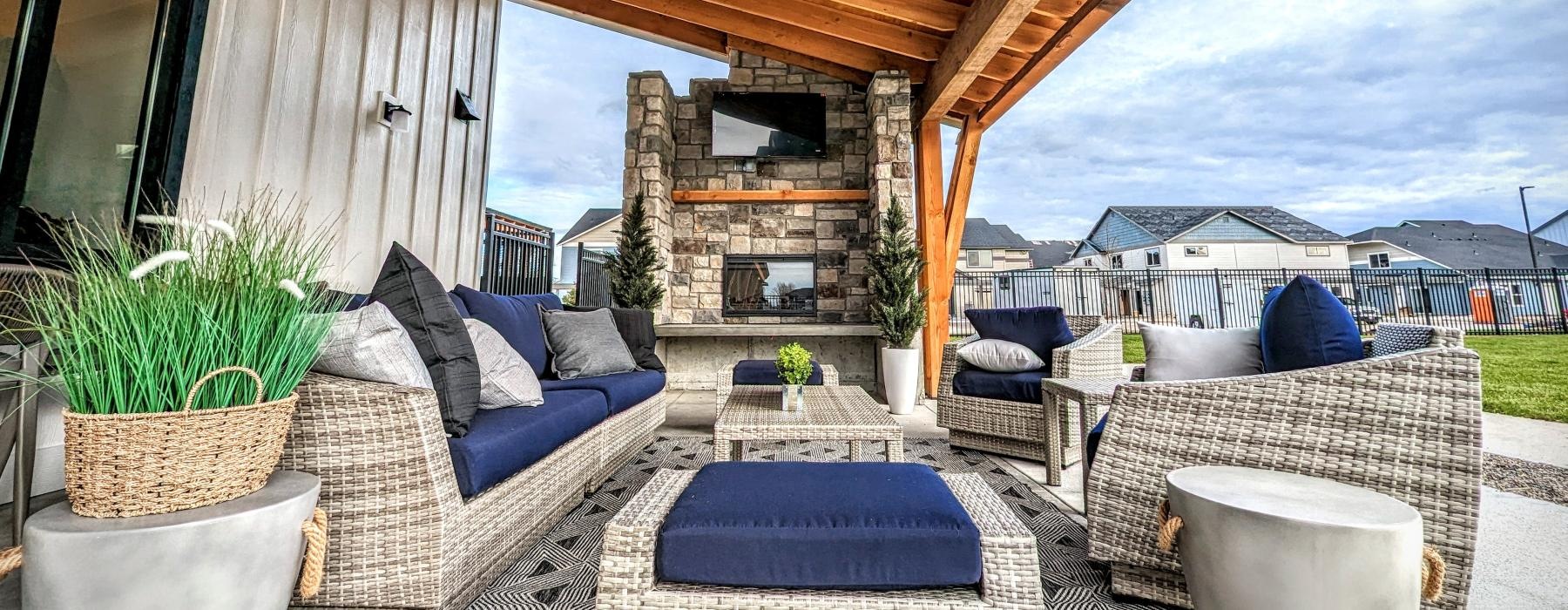 a patio with a fireplace and a patio with a stone patio